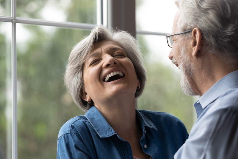 Woman smiling after dental implants derby